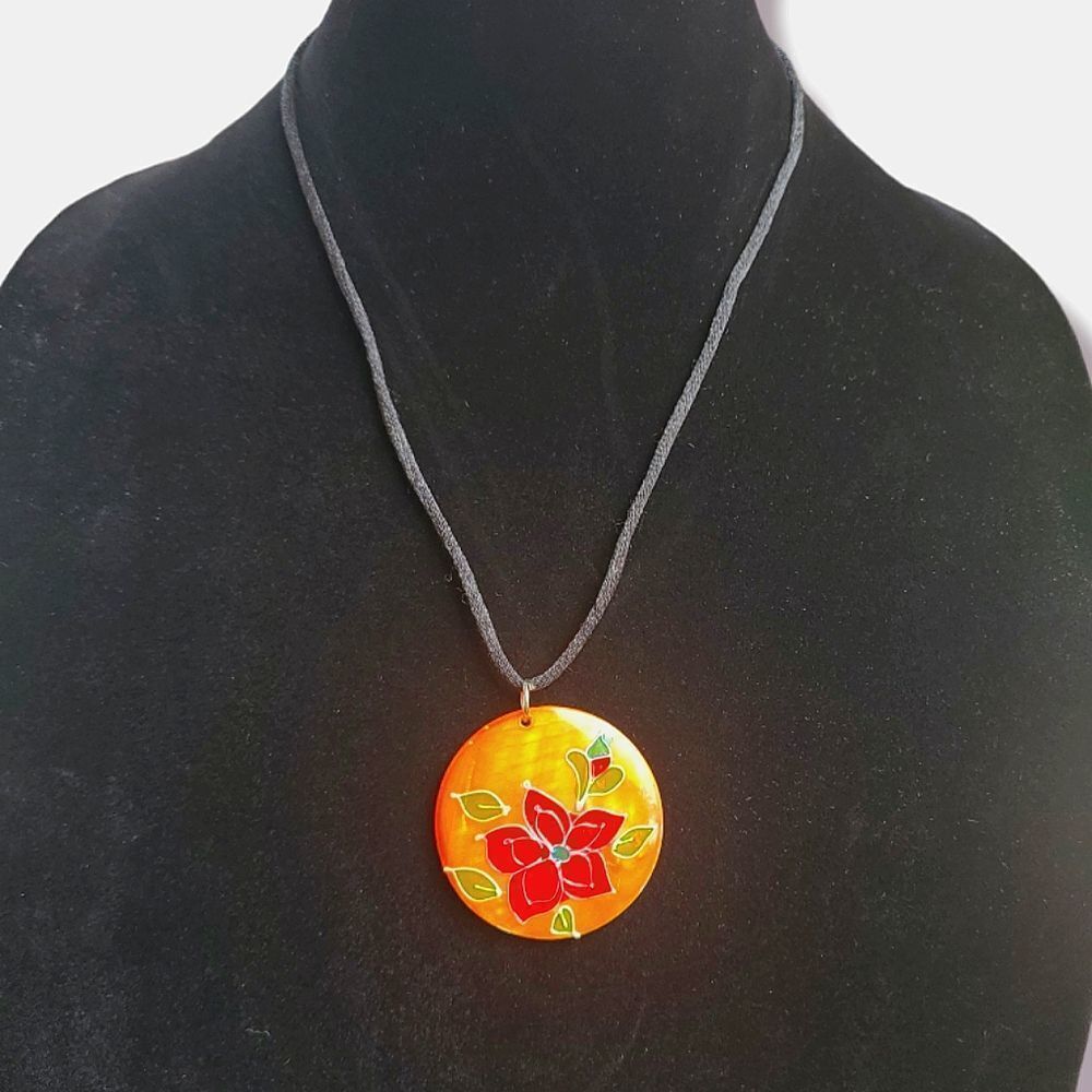 Orange glass medallion pendant with red flower